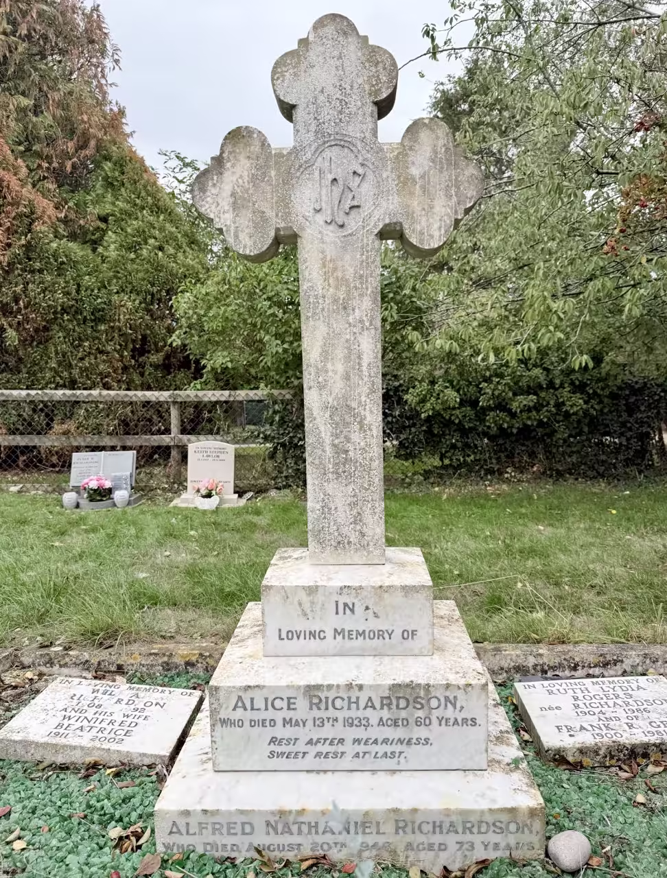 Cross on base within kerbs, urn & 2 plaques