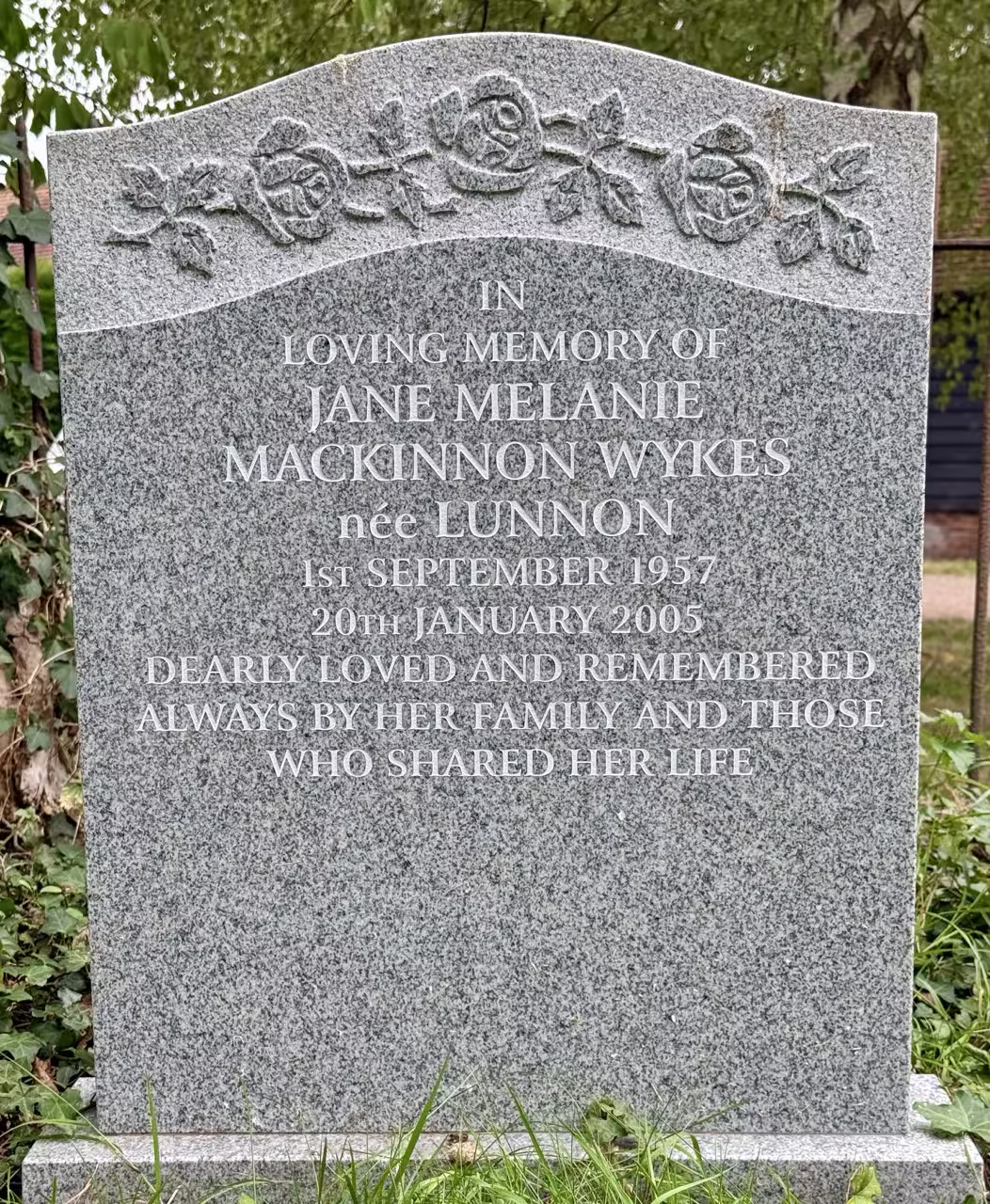 Plaque set at angle & temporary marker by shrub